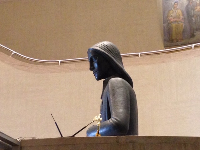 Image of a statue that appears to be standing at a podium