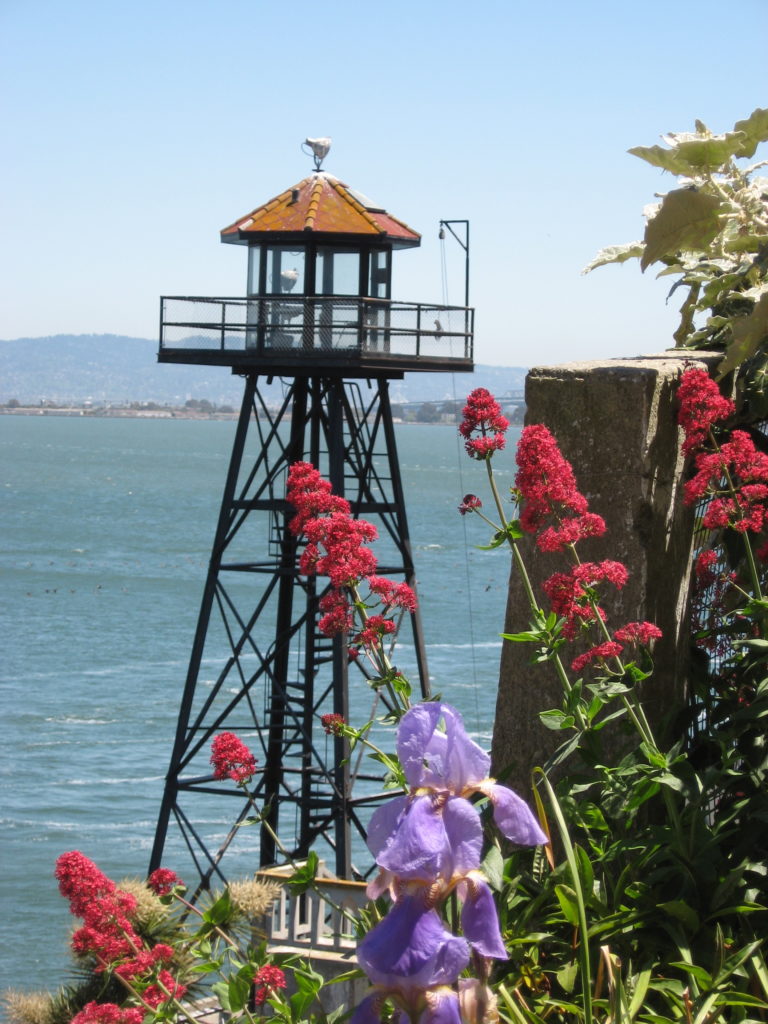 Image of a watch tower at Alcatraz, with the San Francisco Bay in the background.