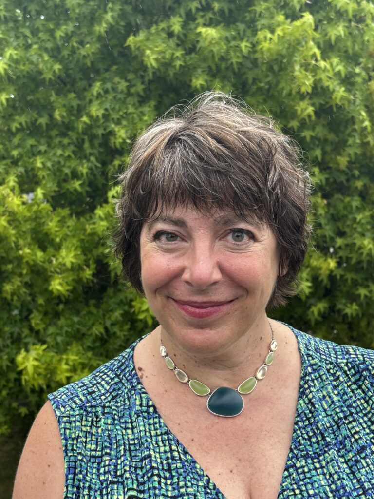 Susan Ferentinos, with green trees in the background